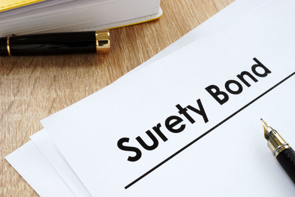 Surety bond form and pen on a table.